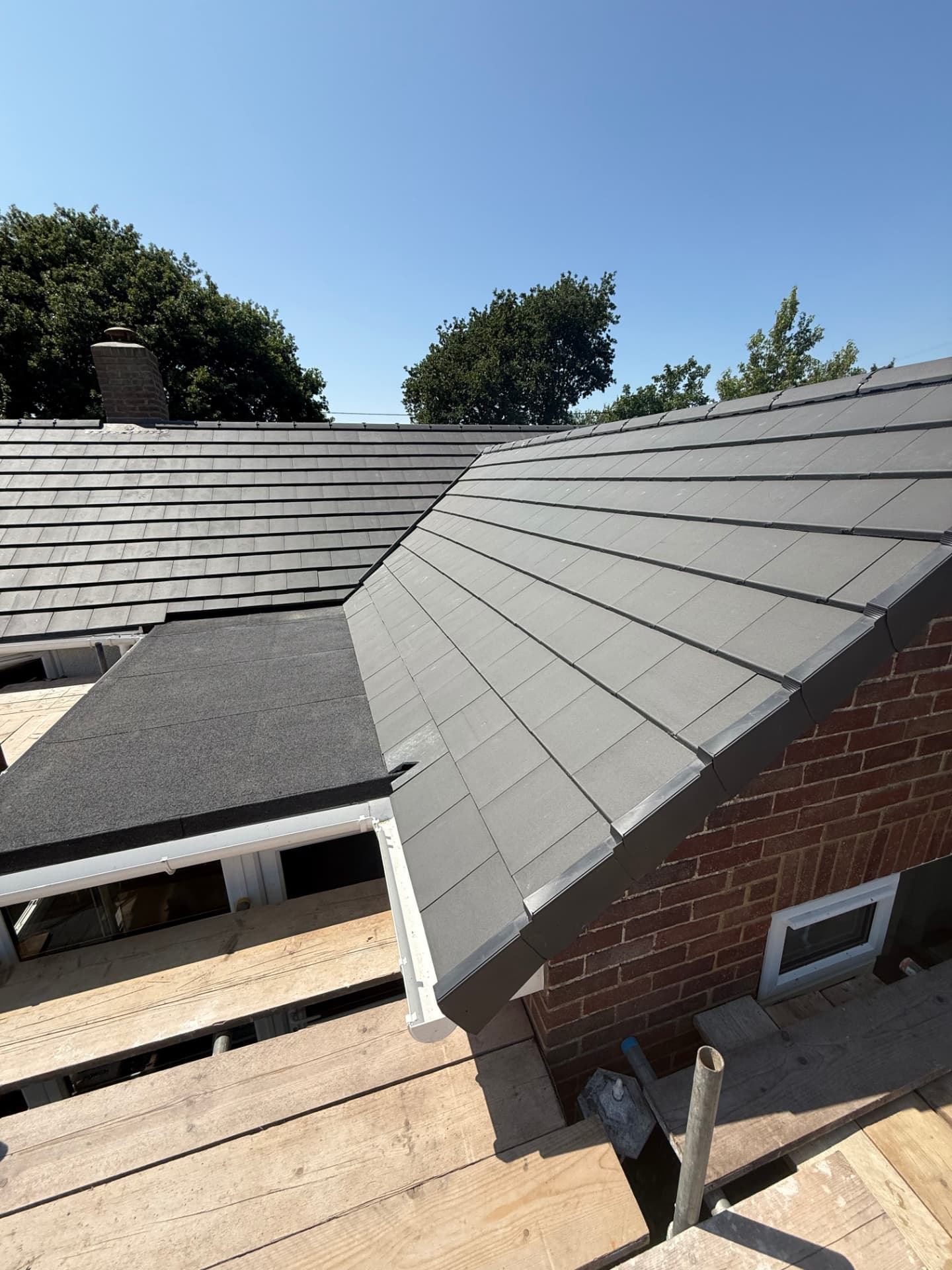 New grey tiled hipped roof on a bungalow