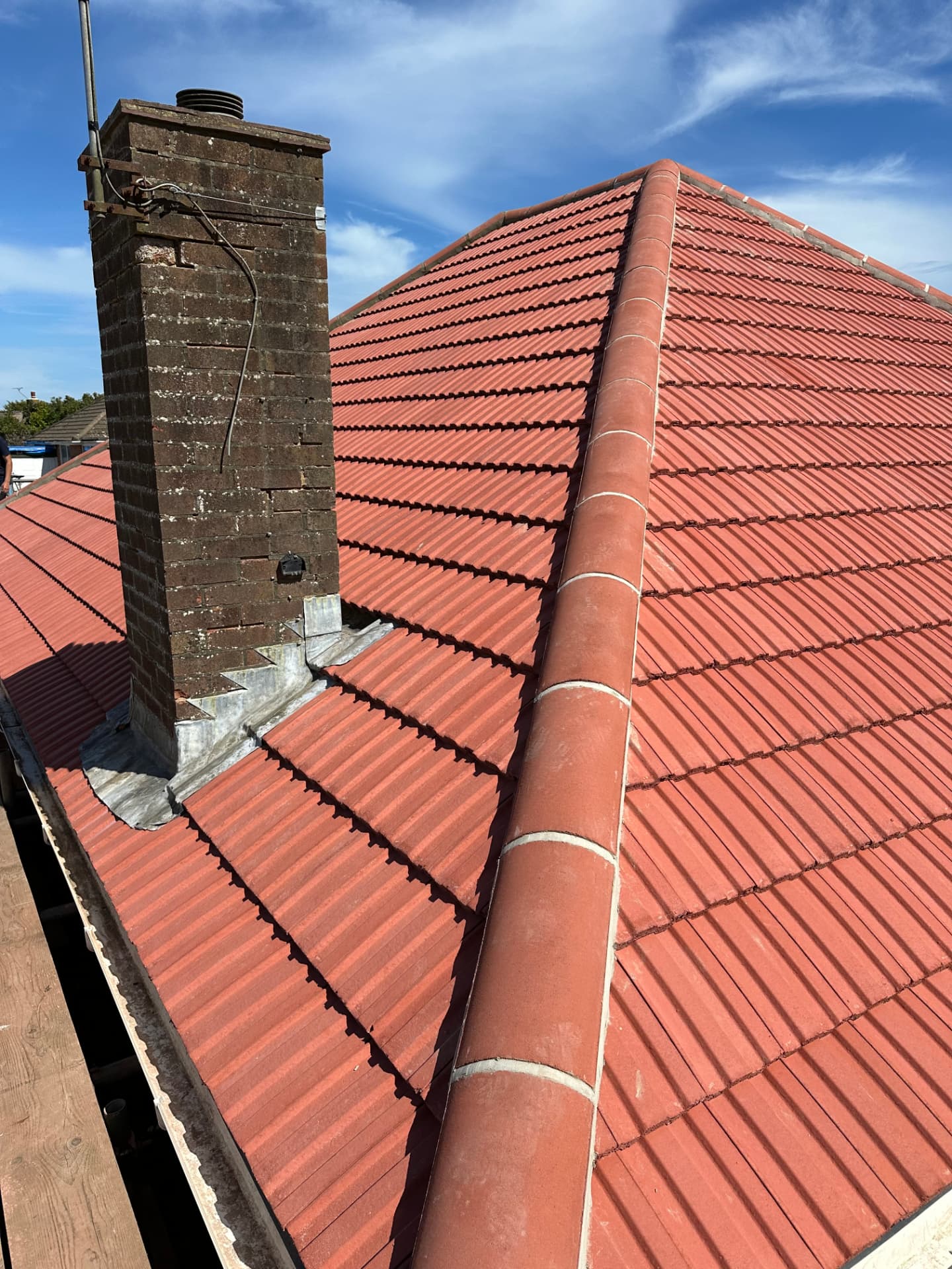 New red tiled pitched roof with lead chimney flashing