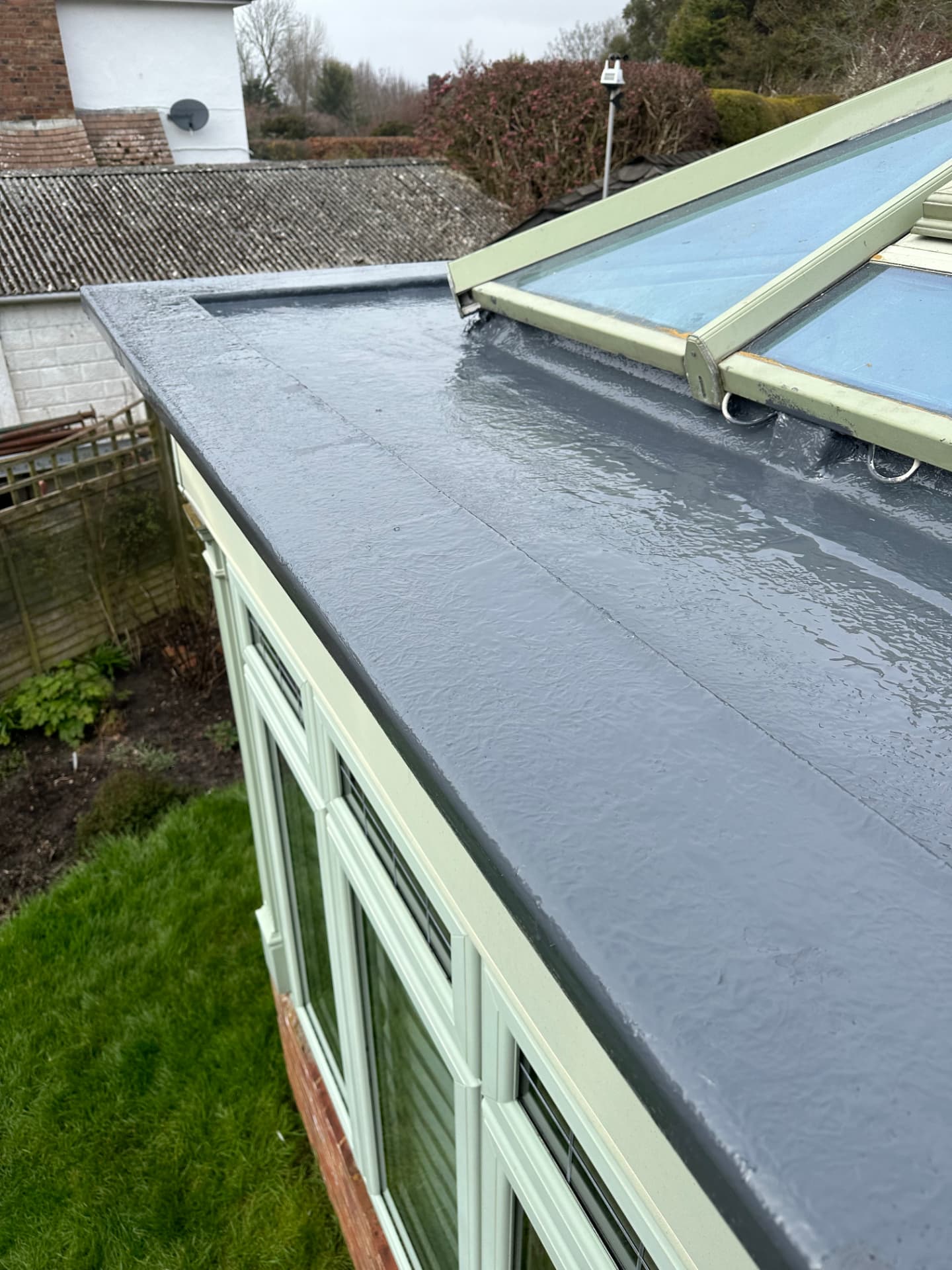 Grey fibreglass flat roof with rooflights